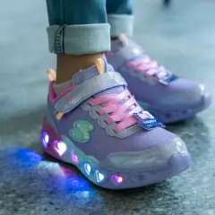 Fioletowe buty dziecięce z brokatem i różowymi sznurówkami. Ich podeszwa świeci kolorowymi serduszkami, tworząc magiczny efekt.
