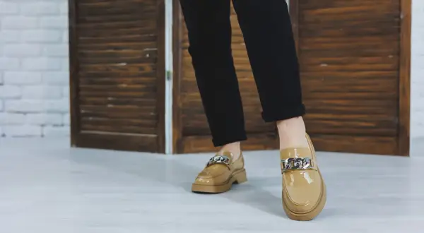 Eleganckie, lakierowane loafersy do sukienki z ozdobnym łańcuchem. Idealne do stylizacji na co dzień i na specjalne okazje.