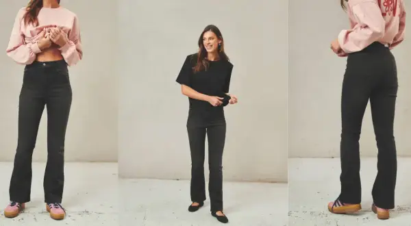 Stylizacje z jeansami dzwonami: modelka w różowym sweterku i czarnej bluzce prezentuje modne jeansy dzwony.
