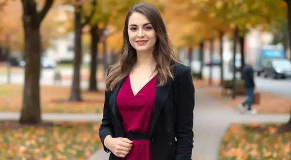 Elegancka kobieta w bordowej sukience i czarnym żakiecie, idealny zestaw na jesienny spacer.