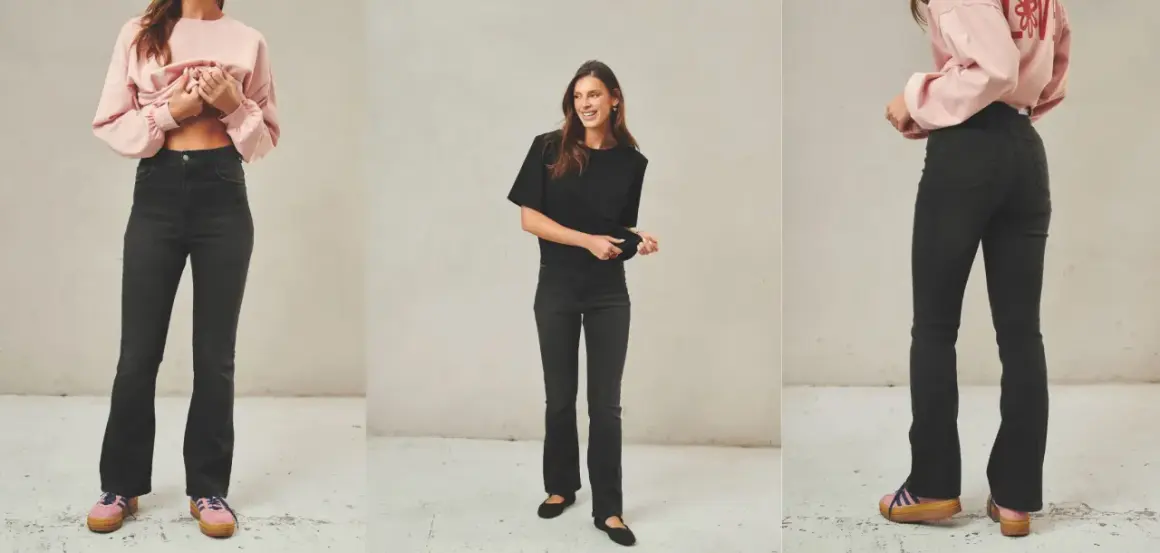 Stylizacje z jeansami dzwonami: modelka w różowym sweterku i czarnej bluzce prezentuje modne jeansy dzwony.