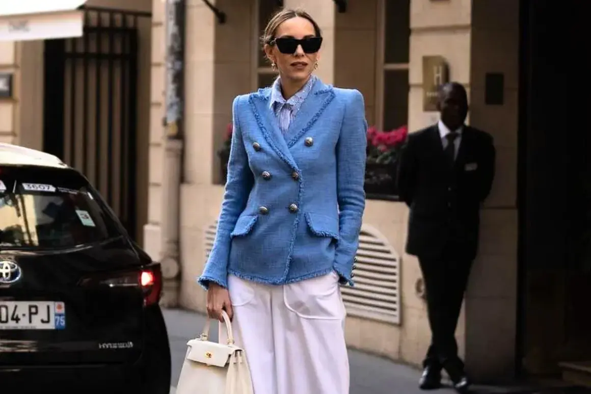 Elegancka kobieta w niebieskiej marynarce i białych spodniach. Inspiracja, jak się ubierać po 40. Stylowo i z klasą.